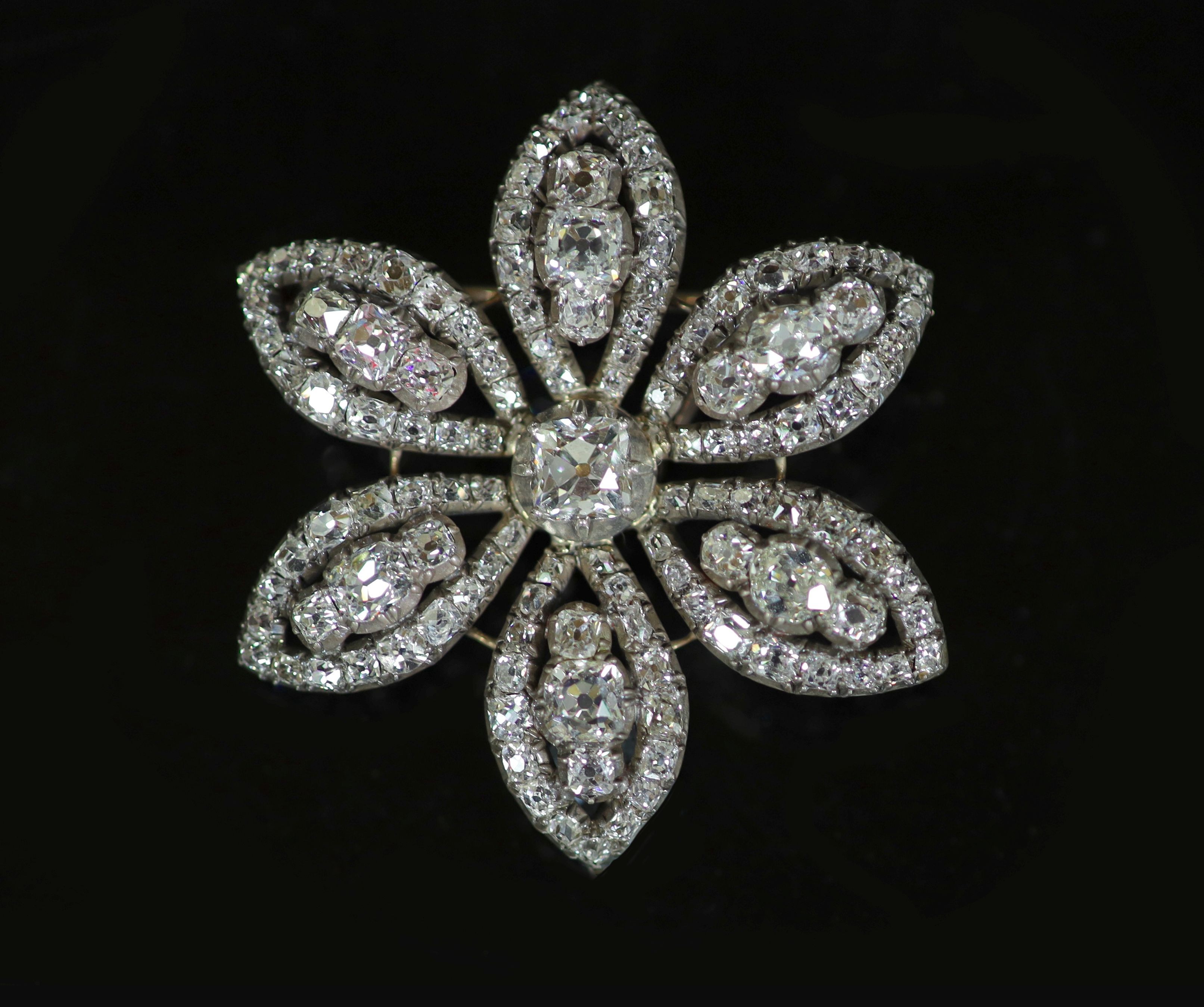 An early 19th century gold, silver and diamond encrusted flower head pendant, with detachable brooch attachment
